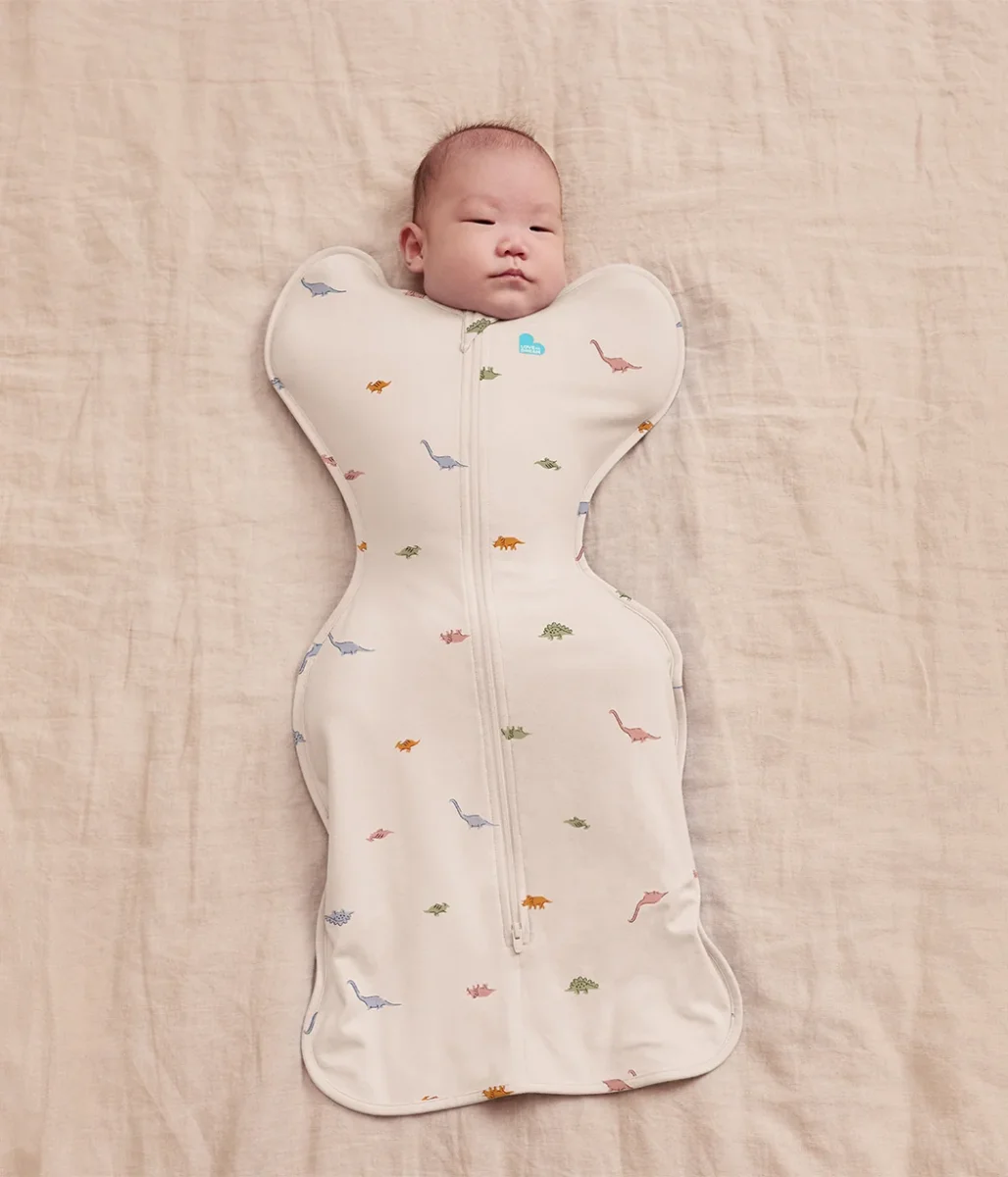 Swaddle Up™ 1.0 TOG de algodón color crema Dino Snore
